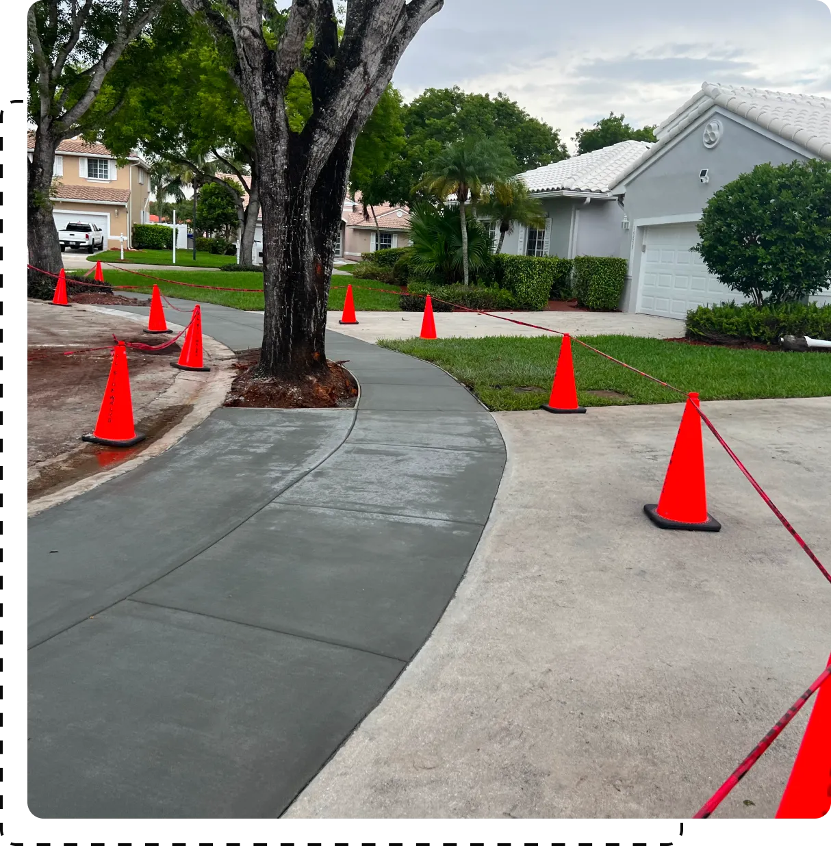 A street with orange cones on the side of it.