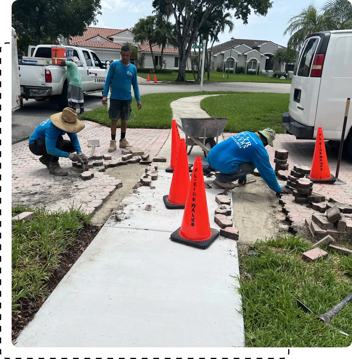 A group of men working on the sidewalk.