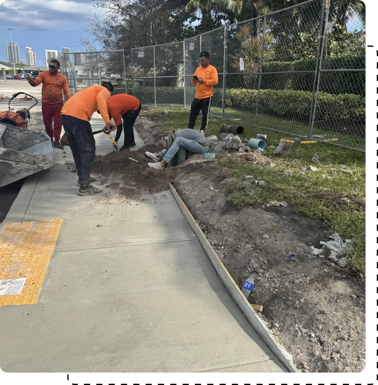 A group of men working on the side of a road.