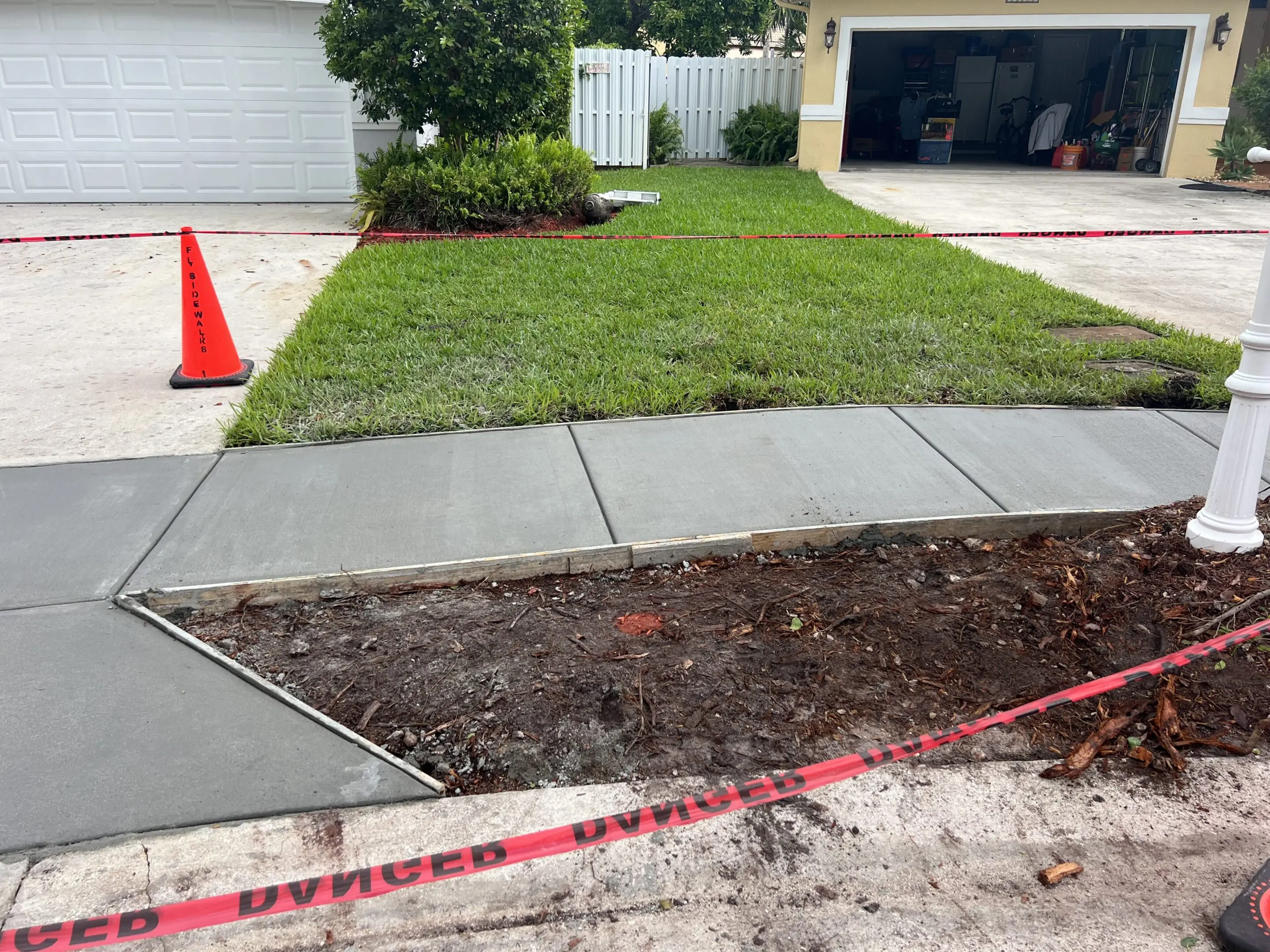 A sidewalk that has been dug out of the ground.