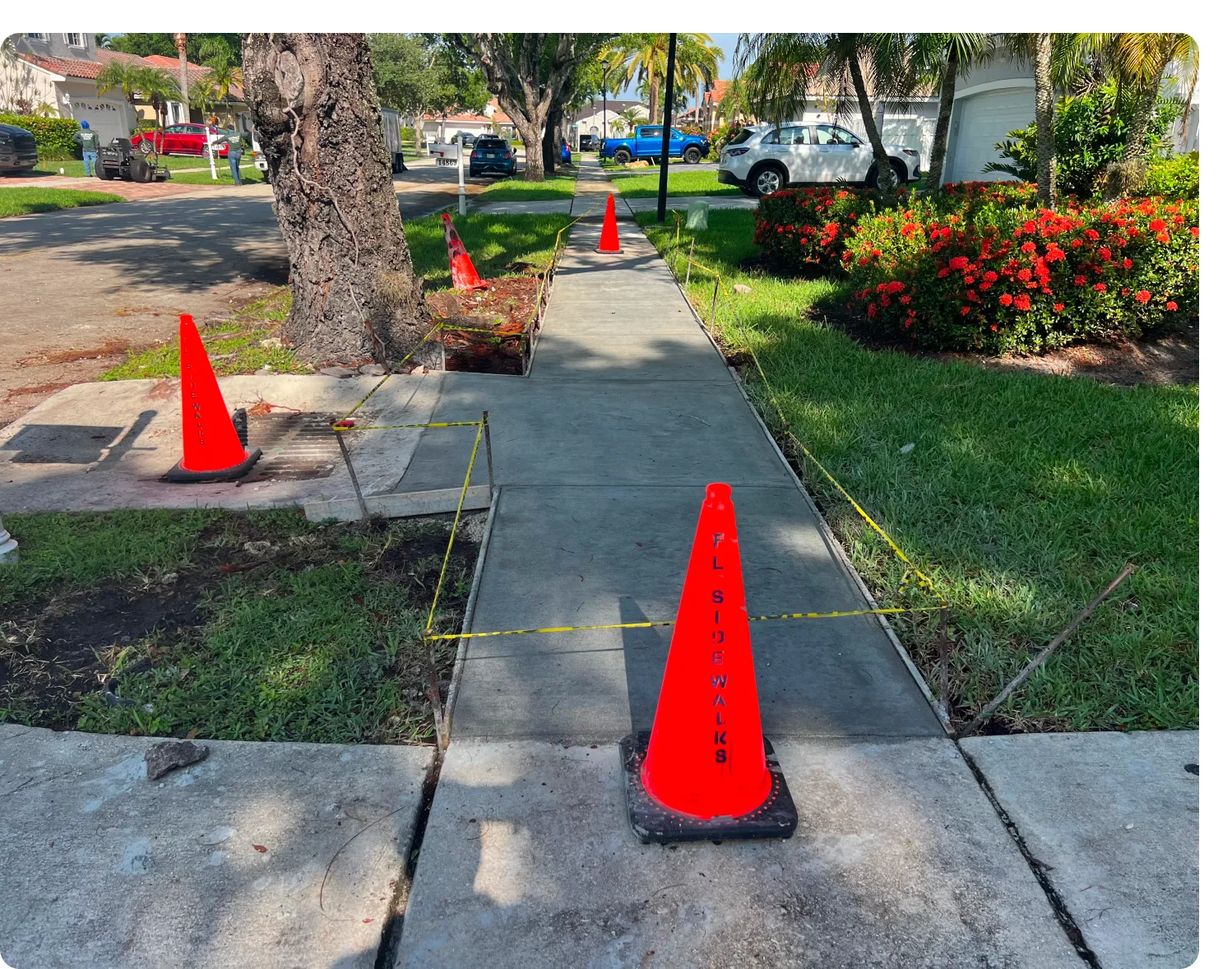 A street with orange cones on the side of it.