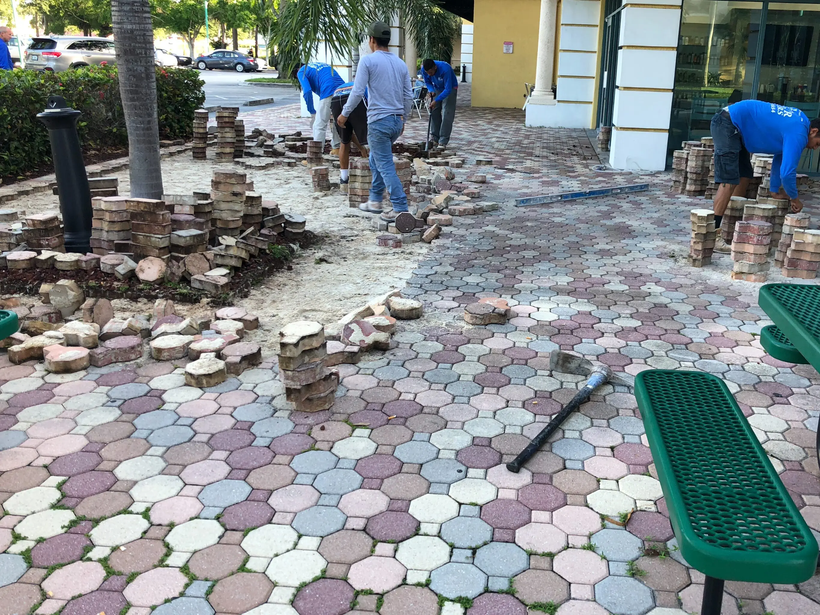 A group of people that are standing around some bricks